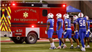 SMU Football Players in front of UPFD Ambulance 