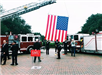 Firefighters Raising Flag Using Fire Truck Ladder