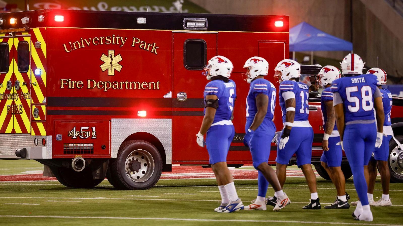 SMU Football Players in front of UPFD Ambulance 