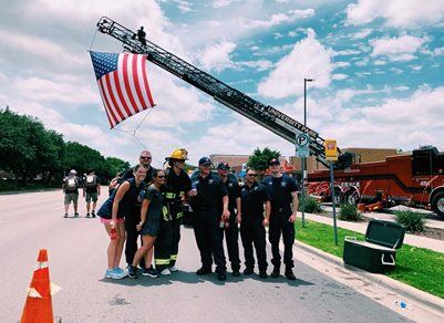 Firefighters Posing for Photo with Fire Truck Displaying American Flag